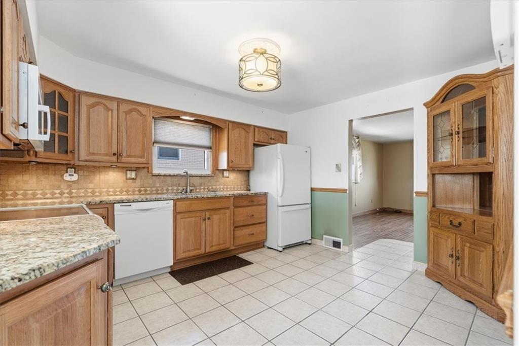 2355 Calvert Street Aliquippa, PA 15001 - Photo 10 of 28 a kitchen with stainless steel appliances granite countertop a stove and a sink