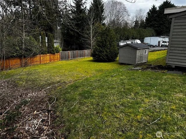 a view of a backyard with a garden and trees