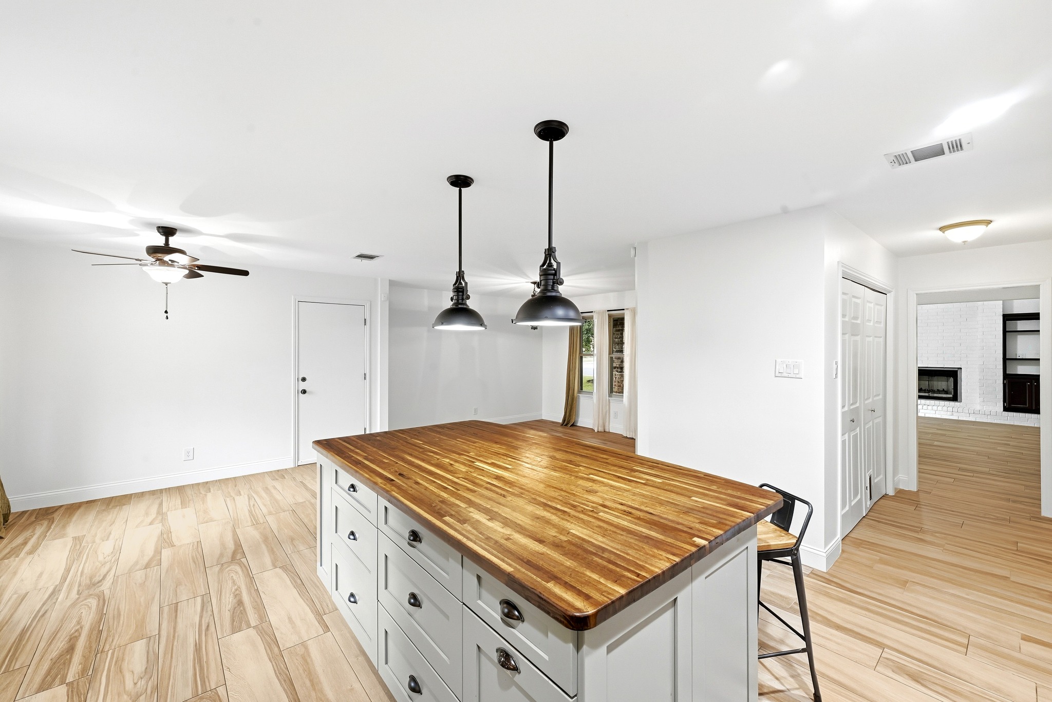11218 Stormy Ridge Road Austin, TX 78739 - Photo 16 of 38 An expansive wood-topped island anchors this modern kitchen featuring tile flooring and clean lines.