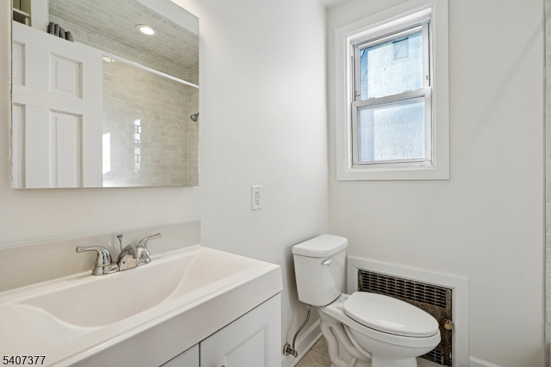 60 Union Avenue Nutley, NJ 07110 - Photo 11 of 17 a bathroom with a sink a toilet and a mirror