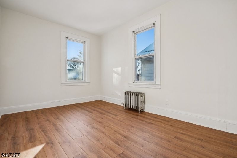 60 Union Avenue Nutley, NJ 07110 - Photo 12 of 17 an empty room with wooden floor and windows