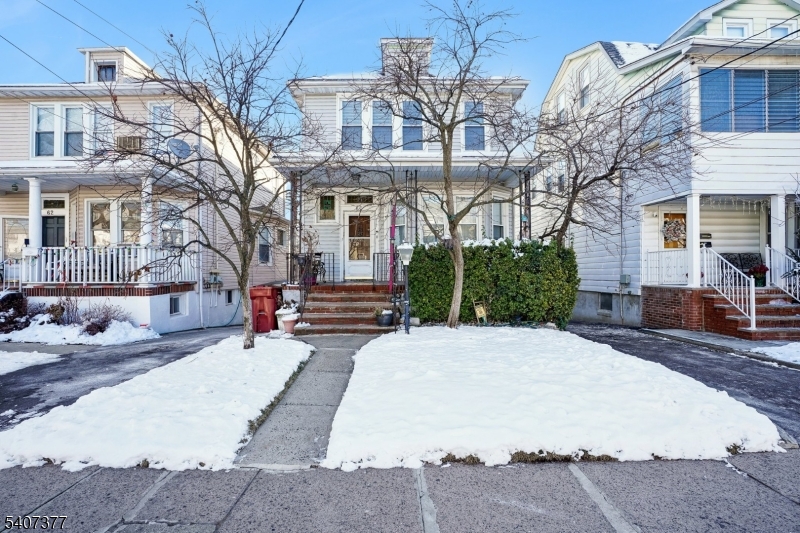 60 Union Avenue Nutley, NJ 07110 - Photo 16 of 17 a front view of a house with a yard covered in snow