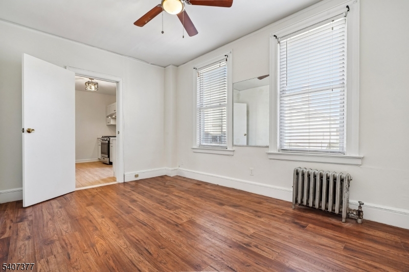 60 Union Avenue Nutley, NJ 07110 - Photo 6 of 17 an empty room with wooden floor and windows