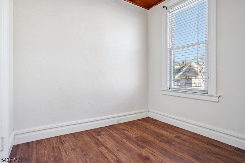 60 Union Avenue Nutley, NJ 07110 - Photo 10 of 17 a view of an empty room with wooden floor and a window