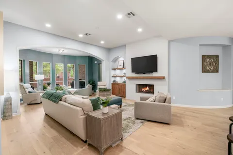a living room with furniture a fireplace and a flat screen tv