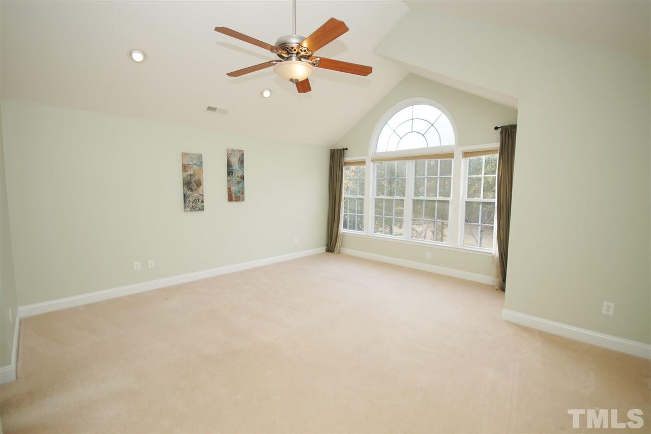 11032 Fair Chase Court Raleigh, NC 27617 - Photo 14 of 25 an empty room with windows and ceiling fan