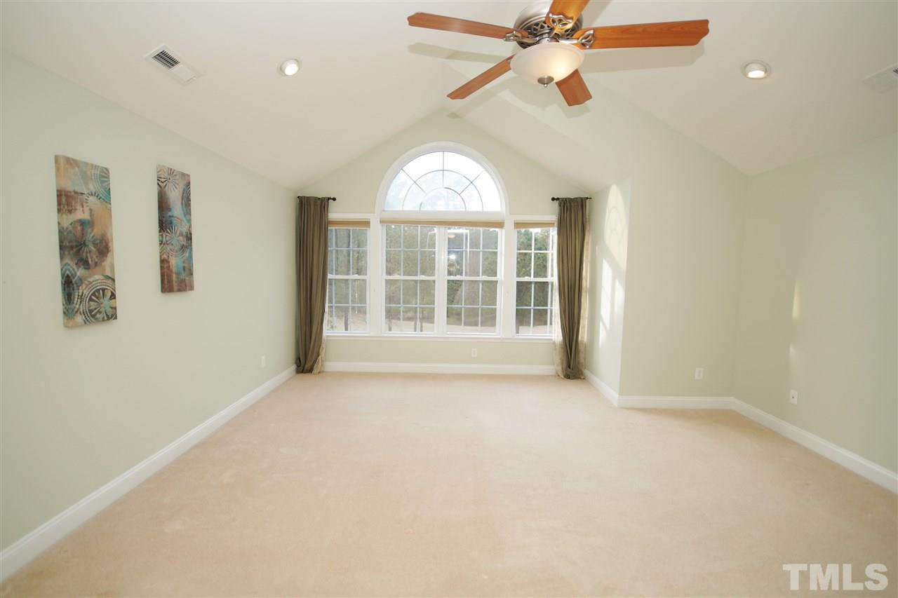 11032 Fair Chase Court Raleigh, NC 27617 - Photo 15 of 25 an empty room with windows and fan