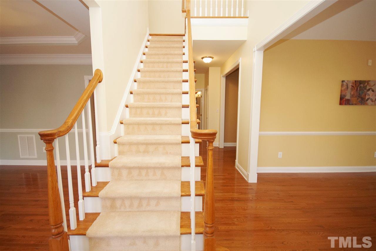 11032 Fair Chase Court Raleigh, NC 27617 - Photo 3 of 25 a view of staircase with white walls and railing