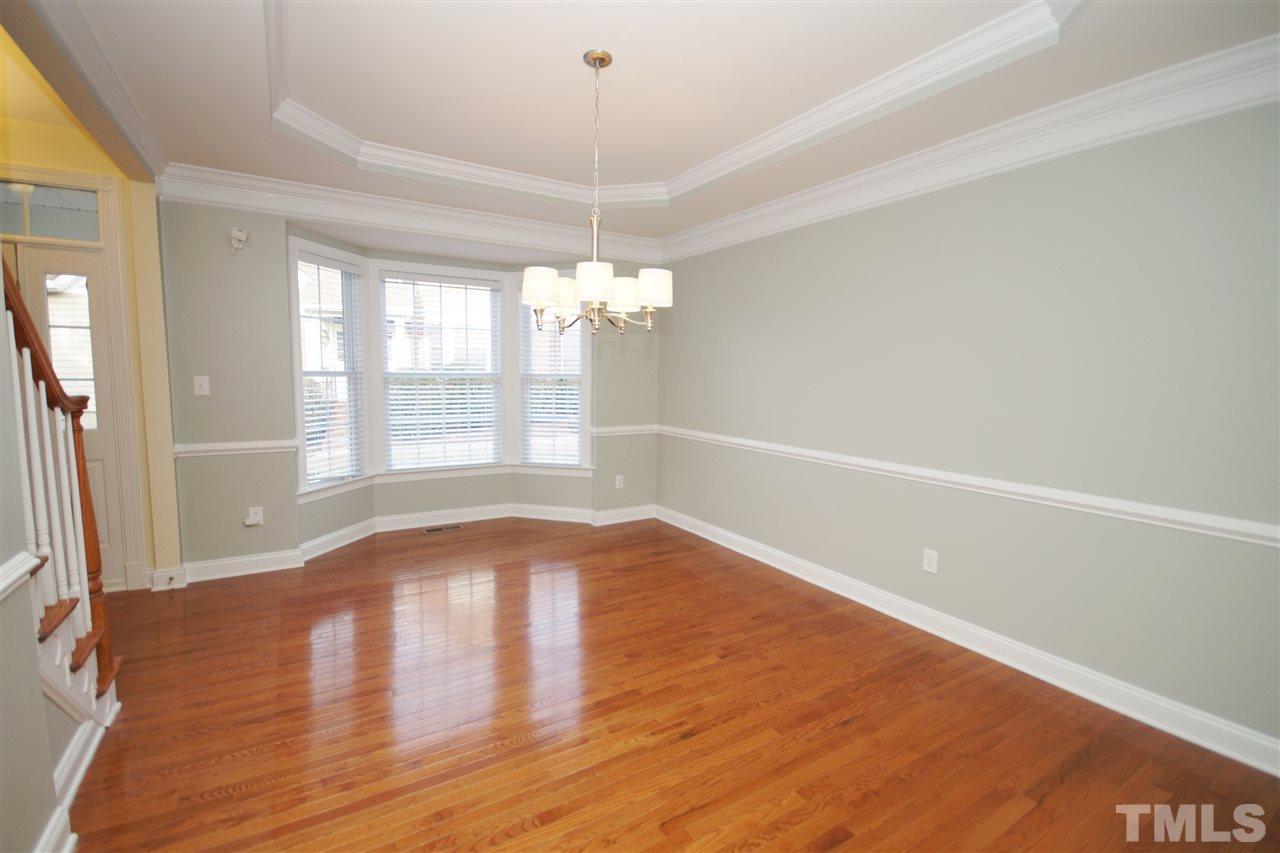 11032 Fair Chase Court Raleigh, NC 27617 - Photo 5 of 25 a view of empty room with wooden floor and fan