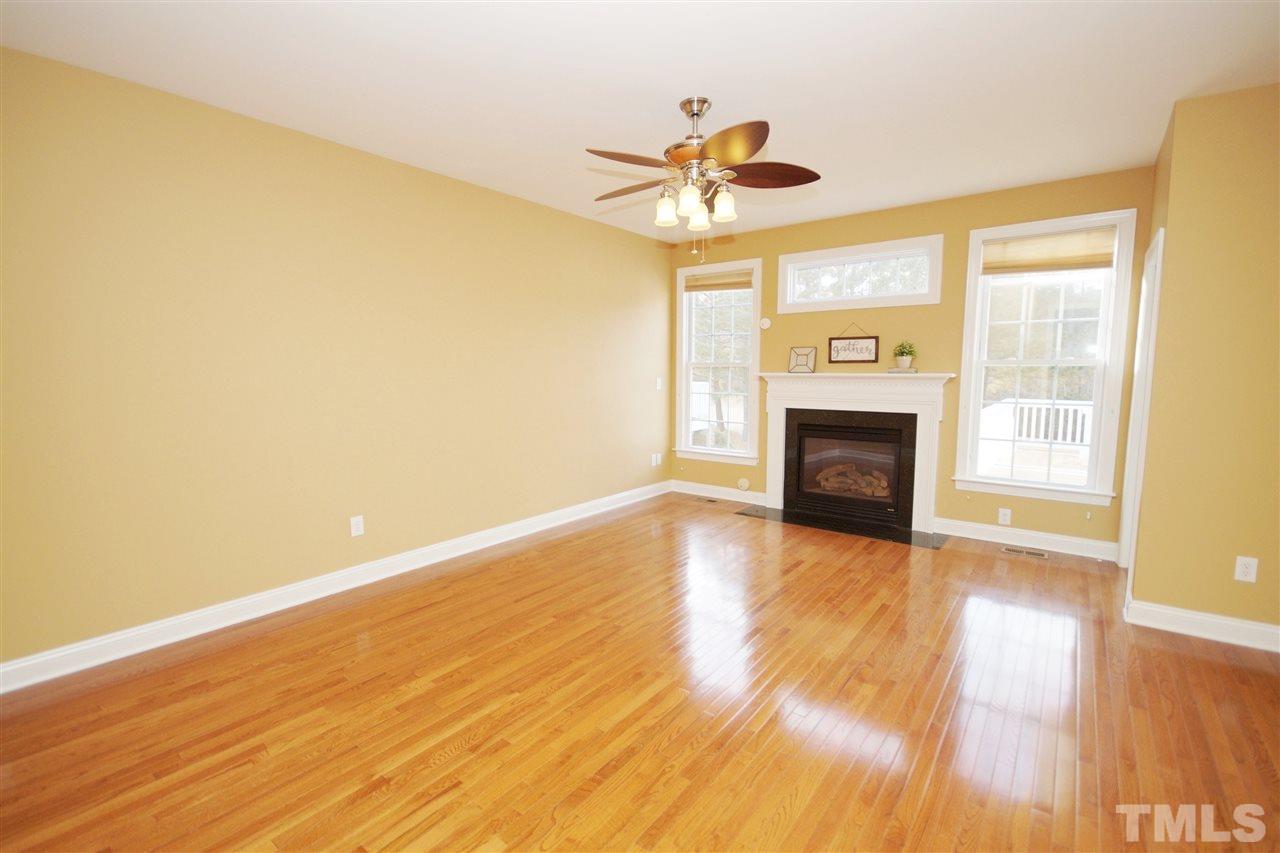 11032 Fair Chase Court Raleigh, NC 27617 - Photo 9 of 25 a view of an empty room with wooden floor and a window