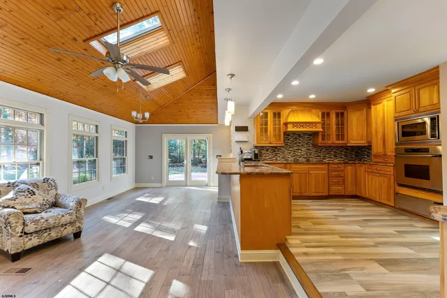 a view of kitchen with granite countertop cabinets and outdoor space