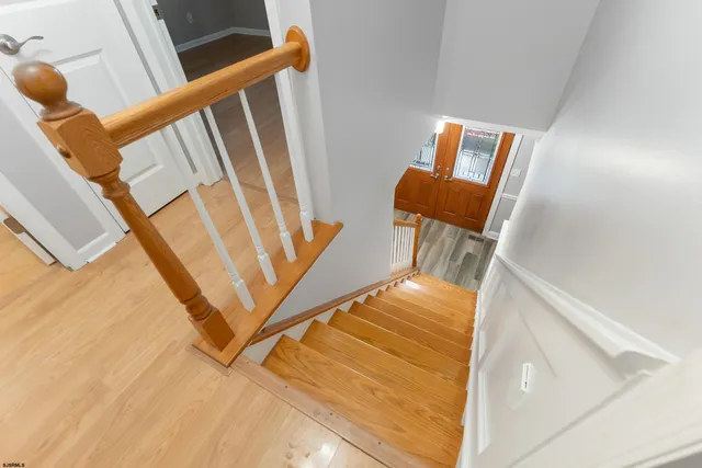 a view of a livingroom with wooden floor and stairs
