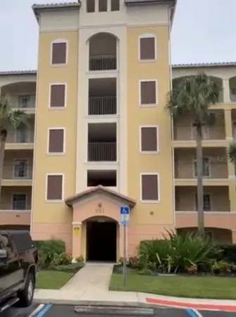 a front view of a building with a garden