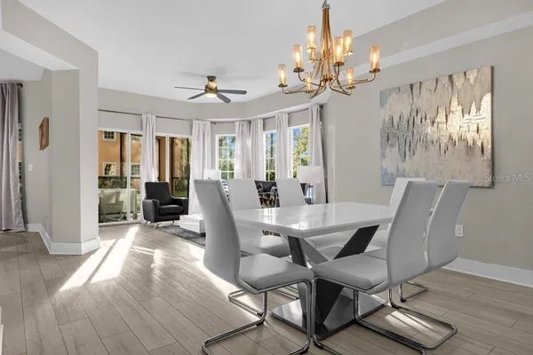 a view of a dining room with furniture wooden floor and chandelier