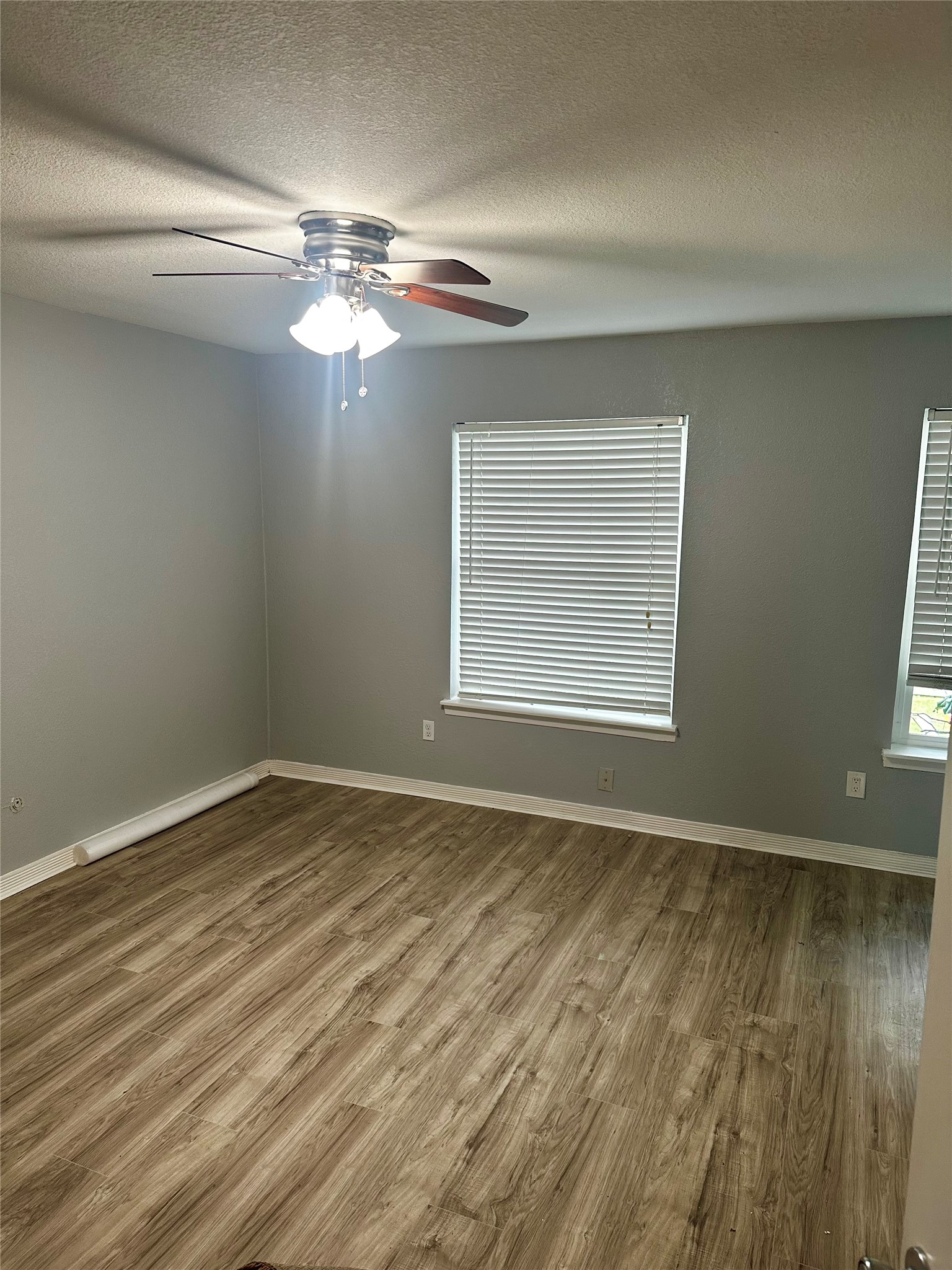 9505 Neuens Road, Unit 10 Houston, TX 77080 - Photo 3 of 7 a view of an empty room with wooden floor and a window