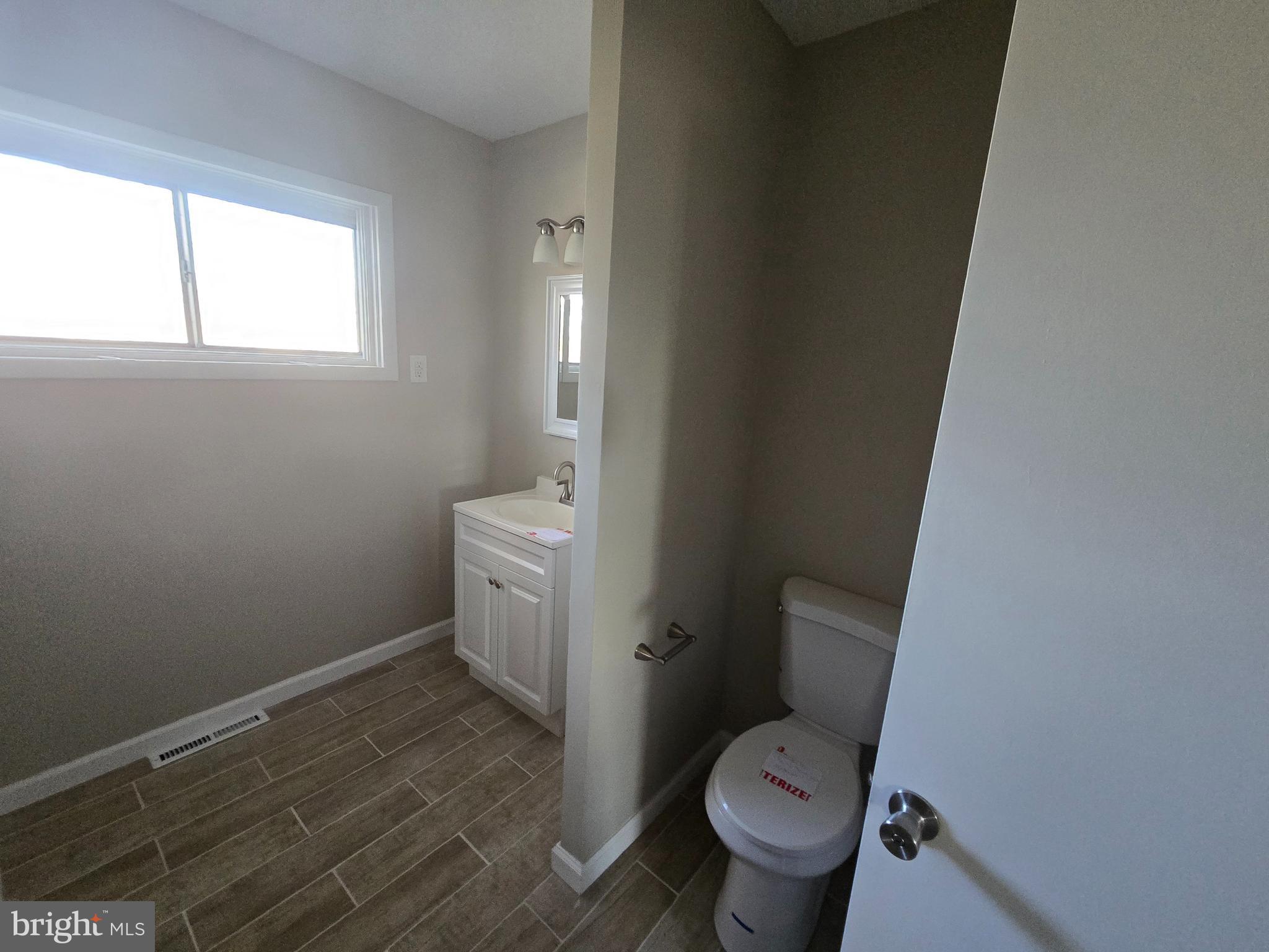 17721 Timberlane Hagerstown, MD 21740 - Photo 10 of 27 a white toilet sitting in a bathroom next to a window