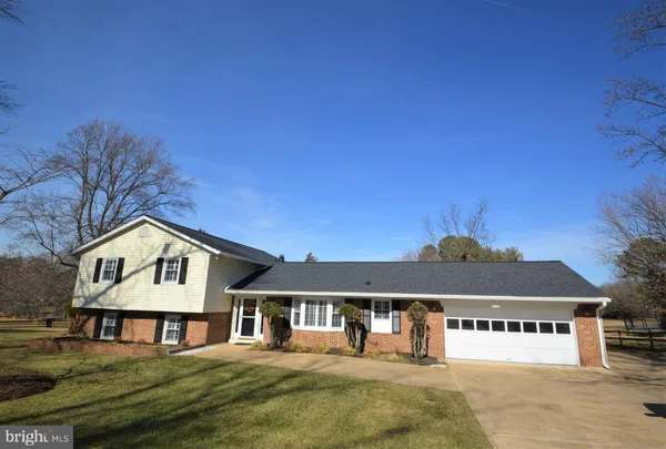 a front view of a house with yard and garage