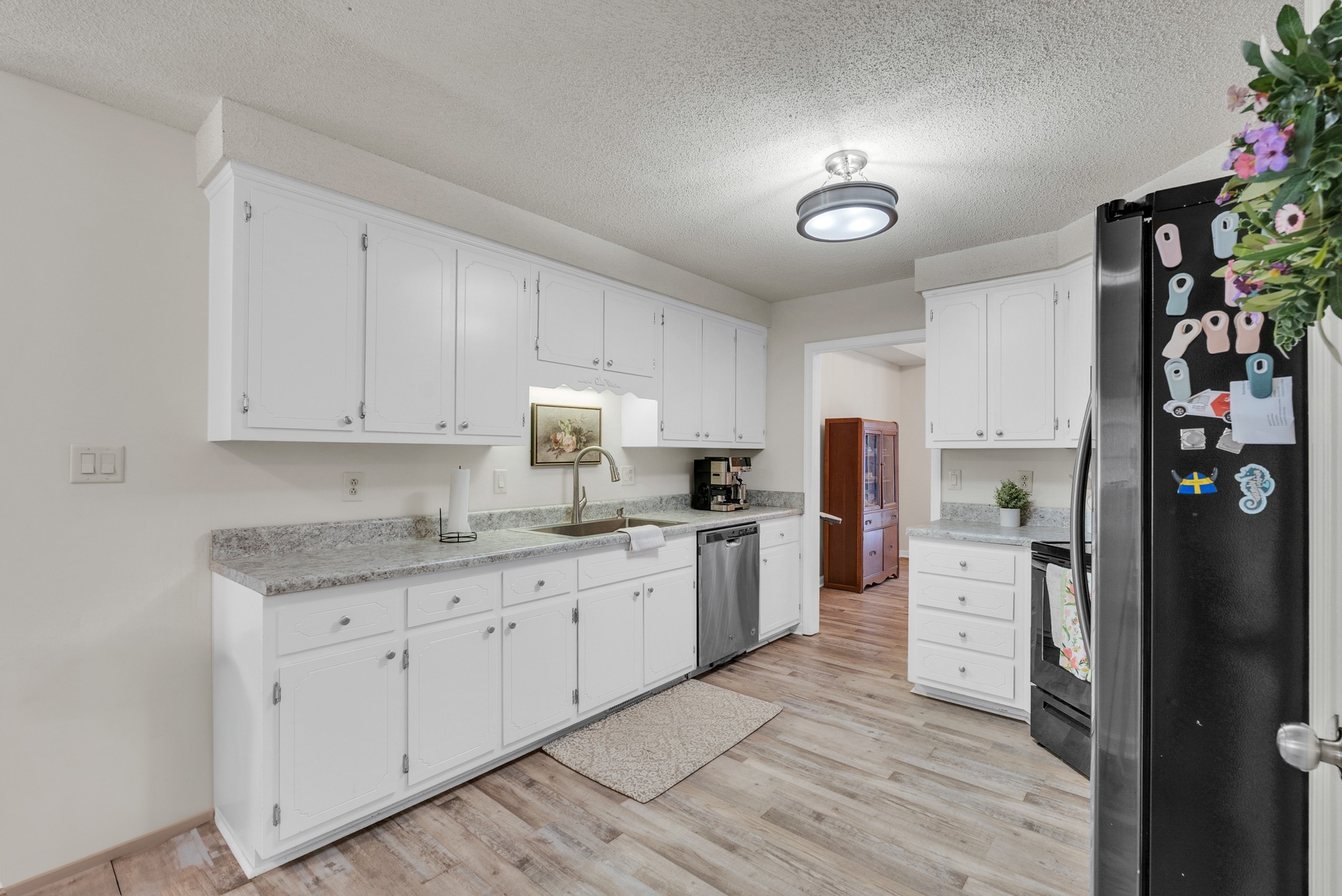 326 Lancaster Road Clarksville, TN 37042 - Photo 10 of 31 a kitchen with granite countertop a refrigerator oven a sink dishwasher and white cabinets with wooden floor