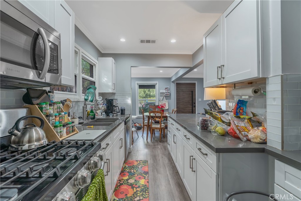 11938 Exposition Boulevard Los Angeles, CA 90064 - Photo 13 of 21 a kitchen filled with a lot of furniture a stove a sink and a refrigerator