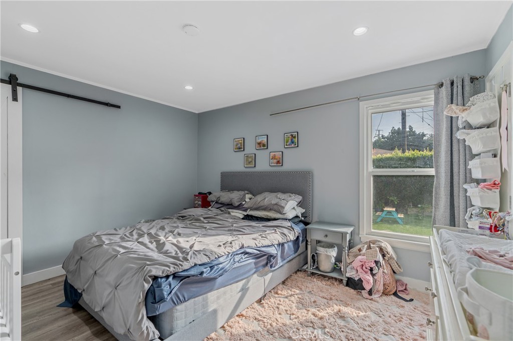 11938 Exposition Boulevard Los Angeles, CA 90064 - Photo 15 of 21 a bedroom with a large bed and a window
