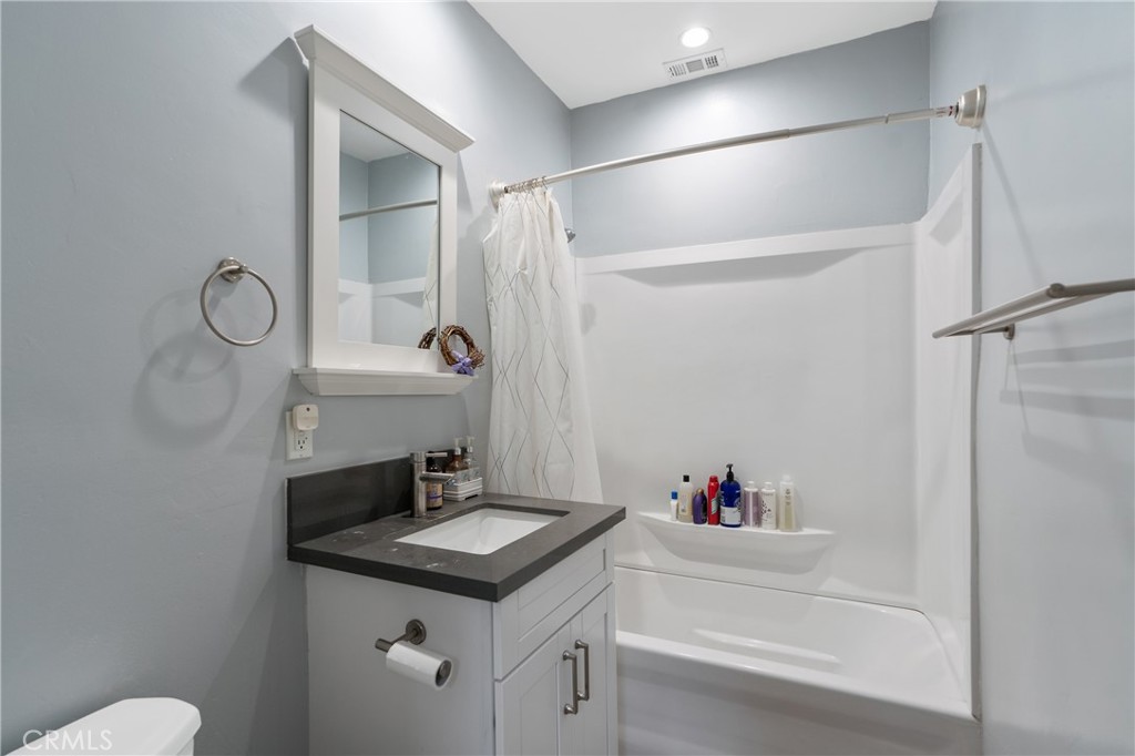 11938 Exposition Boulevard Los Angeles, CA 90064 - Photo 16 of 21 a bathroom with a sink vanity mirror and toilet
