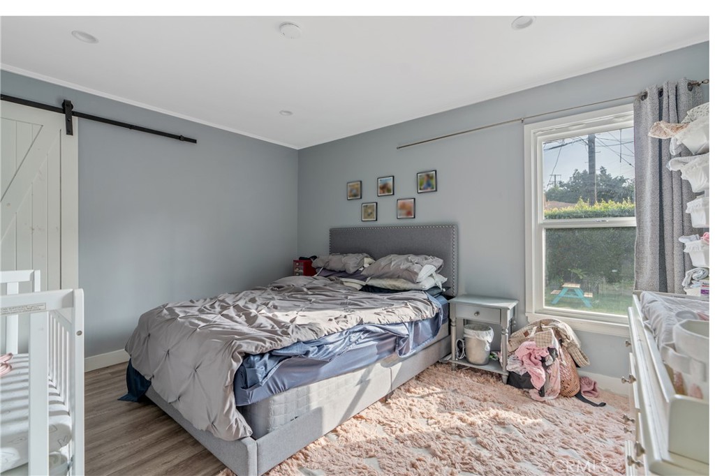 11938 Exposition Boulevard Los Angeles, CA 90064 - Photo 3 of 21 a bedroom with a bed and glass door
