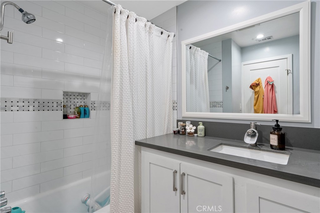 11938 Exposition Boulevard Los Angeles, CA 90064 - Photo 4 of 21 a bathroom with a granite countertop sink and a mirror
