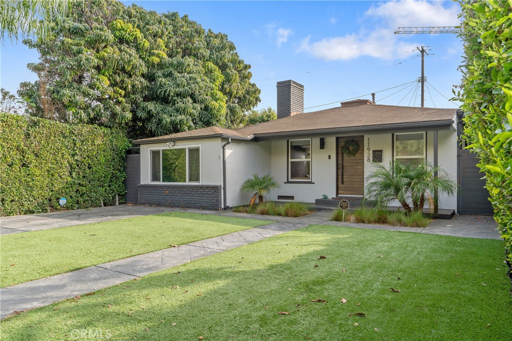 11938 Exposition Boulevard Los Angeles, CA 90064 - Photo 5 of 21 a view of a house with a yard and plants