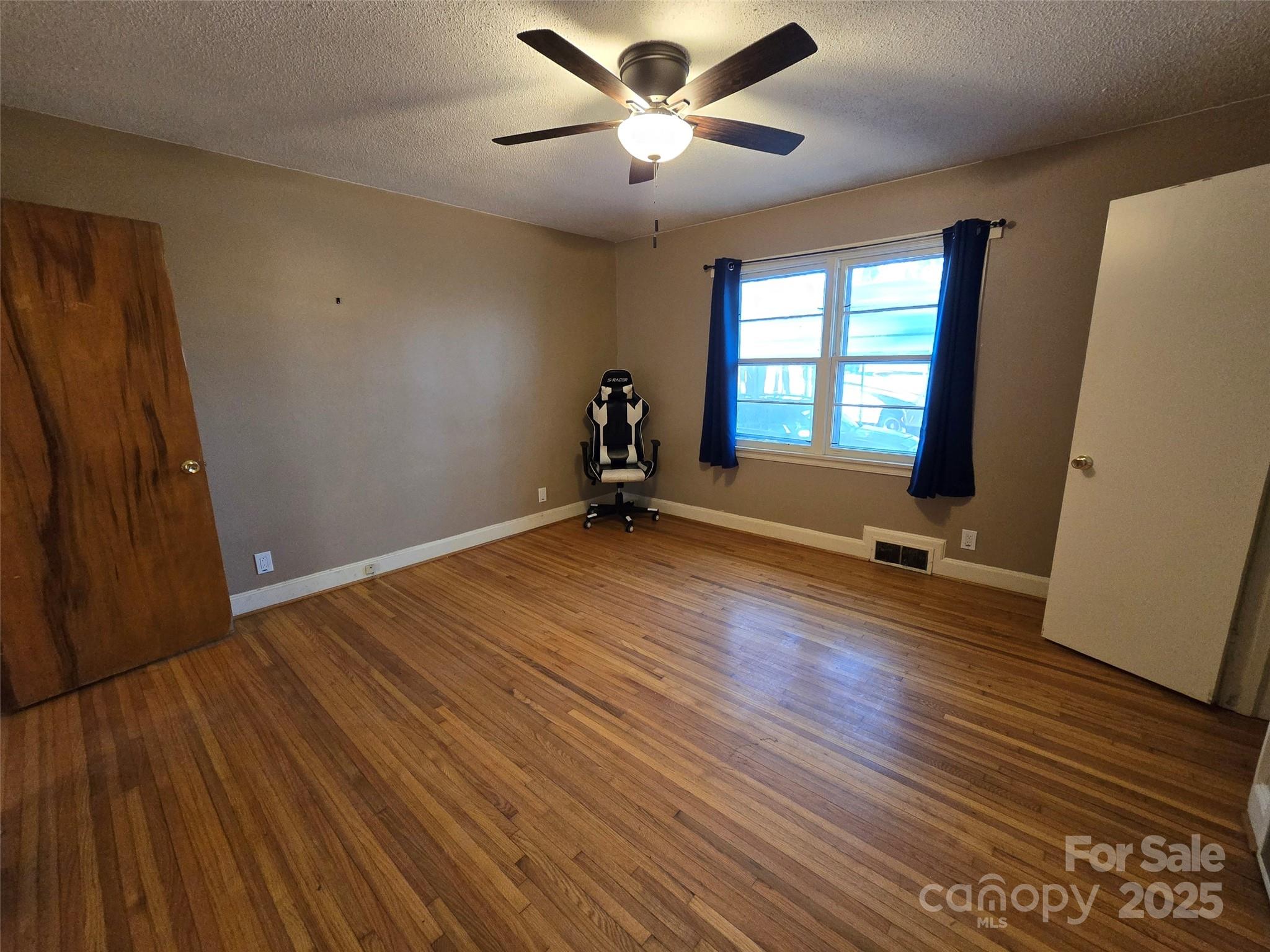 160 Williamson Street Troy, NC 27371 - Photo 16 of 24 an empty room with wooden floor and windows