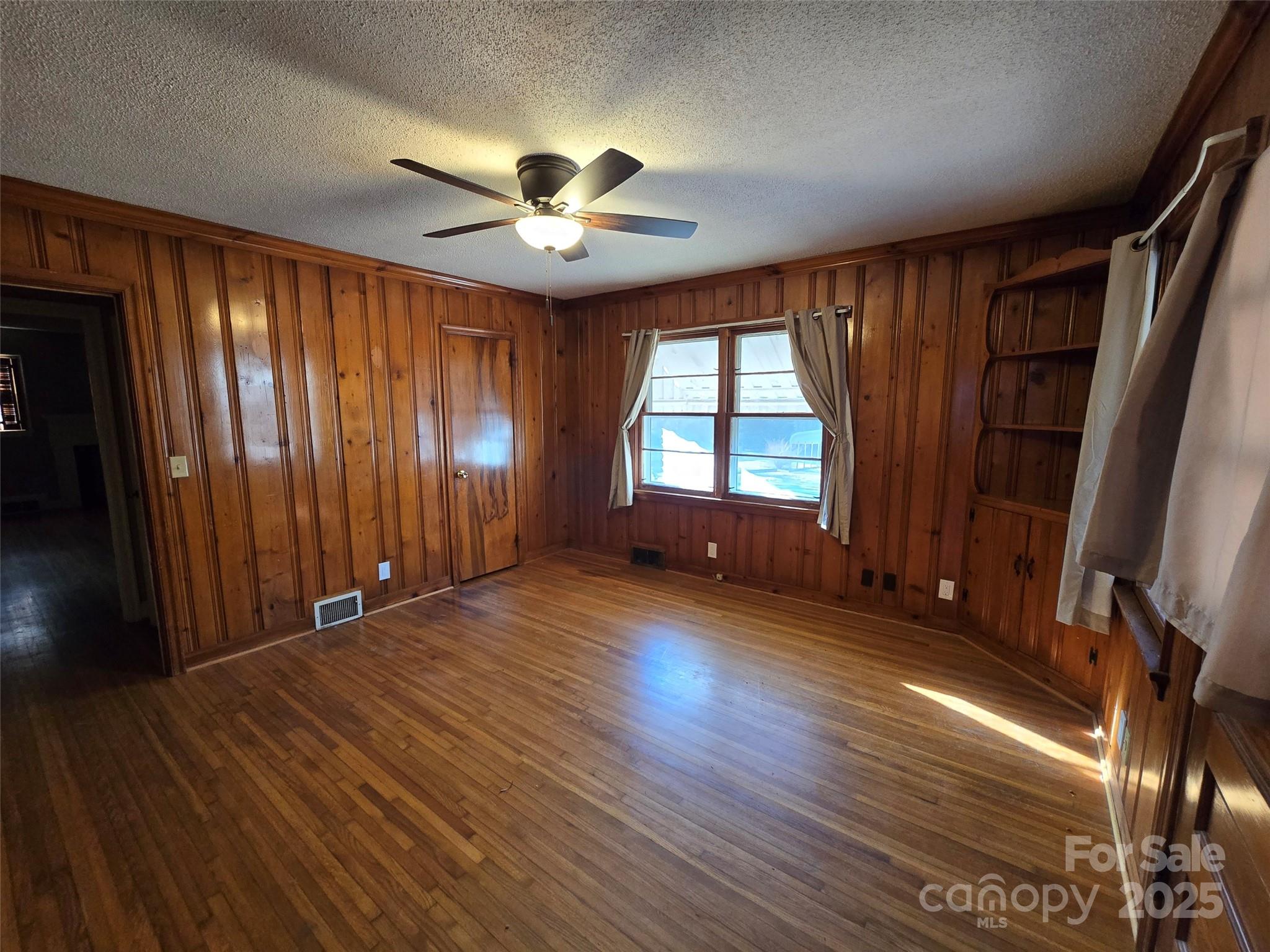 160 Williamson Street Troy, NC 27371 - Photo 4 of 24 wooden floor in an empty room with a window