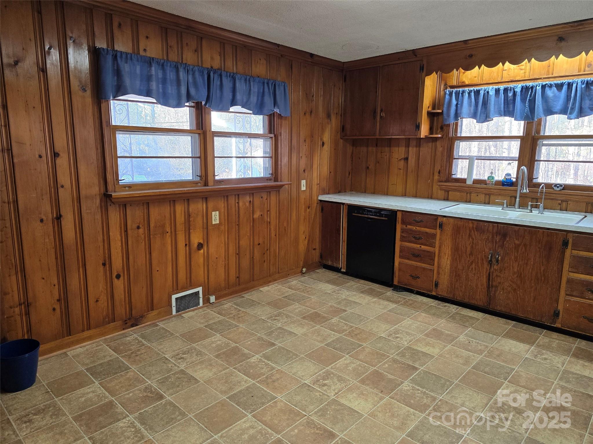 160 Williamson Street Troy, NC 27371 - Photo 7 of 24 a view of a kitchen with a sink and wooden cabinets