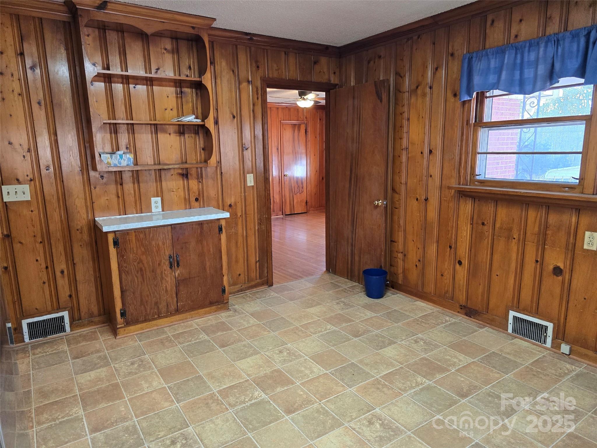160 Williamson Street Troy, NC 27371 - Photo 8 of 24 a view of a livingroom with an empty space and wooden shelves