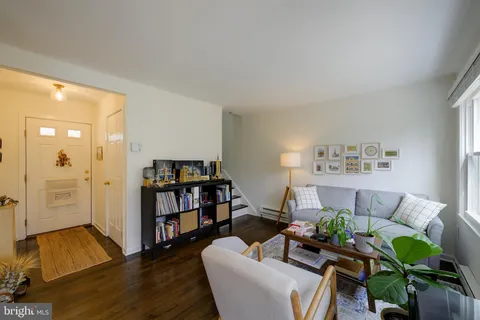 a living room with furniture and a book shelf