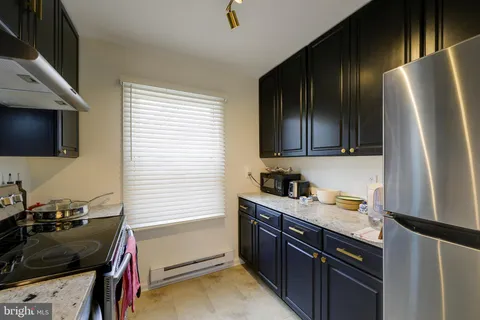 a kitchen with a sink appliances and cabinets