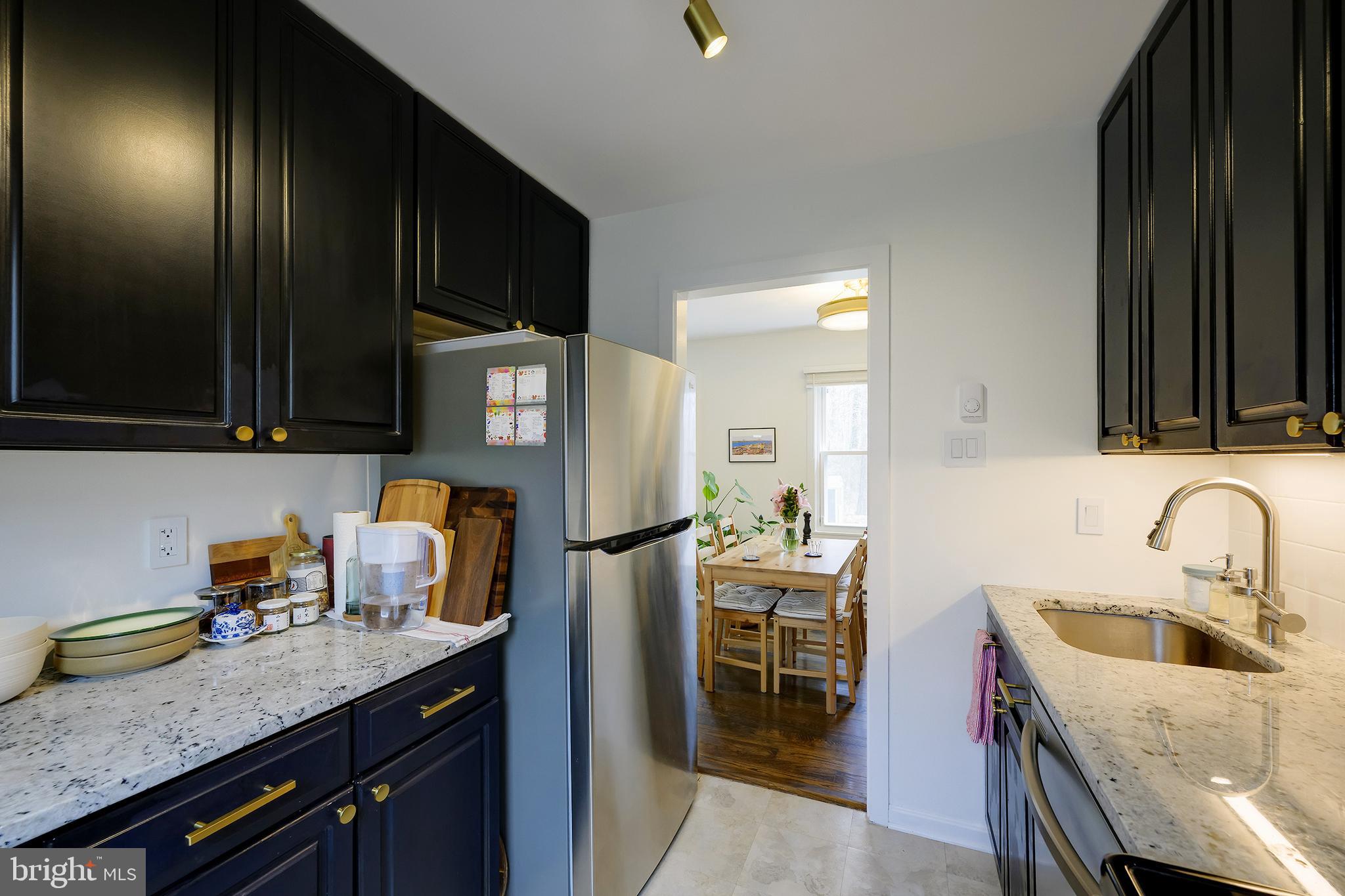 14 Laurel Hill Road Greenbelt, MD 20770 - Photo 18 of 41 a kitchen with stainless steel appliances granite countertop a sink a stove and a refrigerator