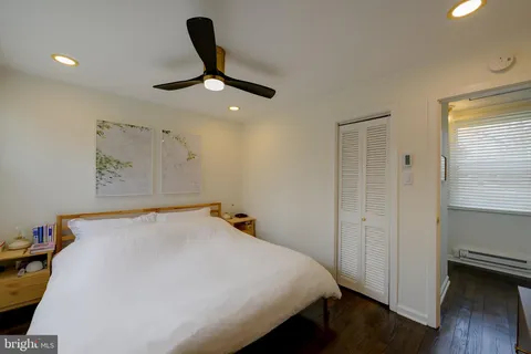 a bedroom with a bed and a large window