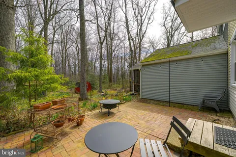 a backyard of a house with table and chairs