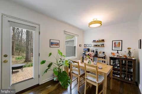 a view of a dining room with furniture and a window