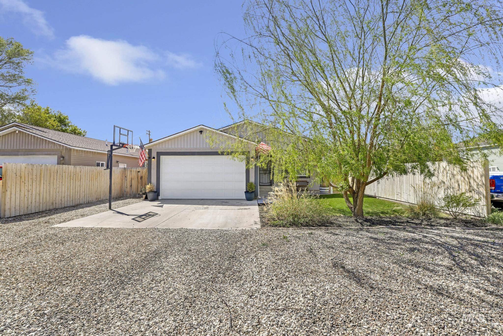 Single-story residence featuring a two-tone exterior, a prominent garage with a white door, and a concrete driveway