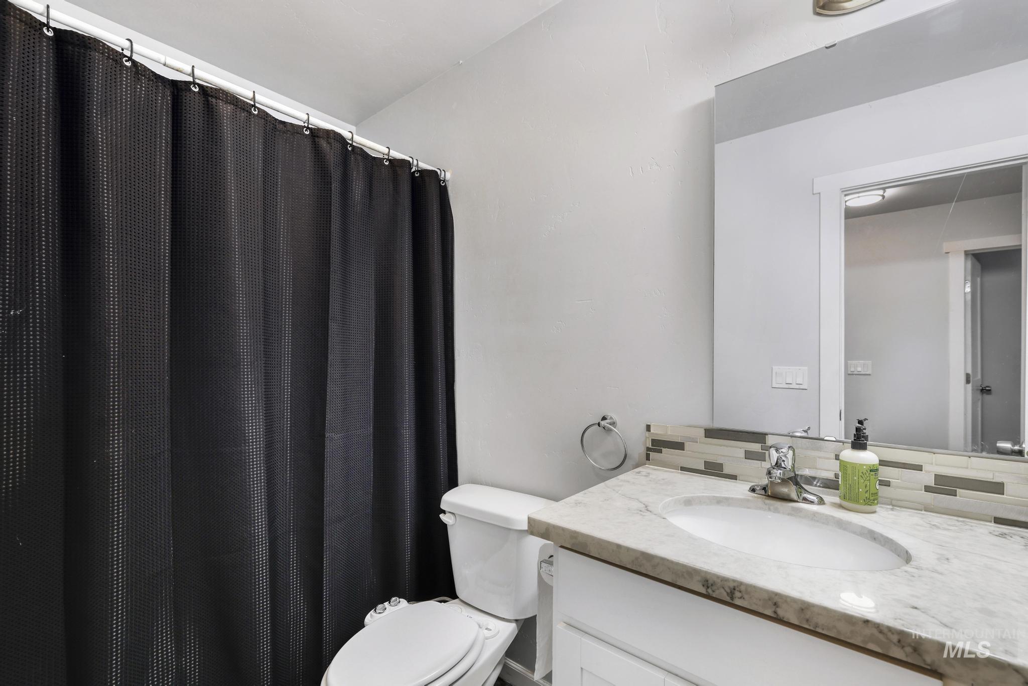 826 Normal Burley, ID 83318 - Photo 13 of 21 Bathroom featuring a vanity with a light-toned countertop and an undermount sink