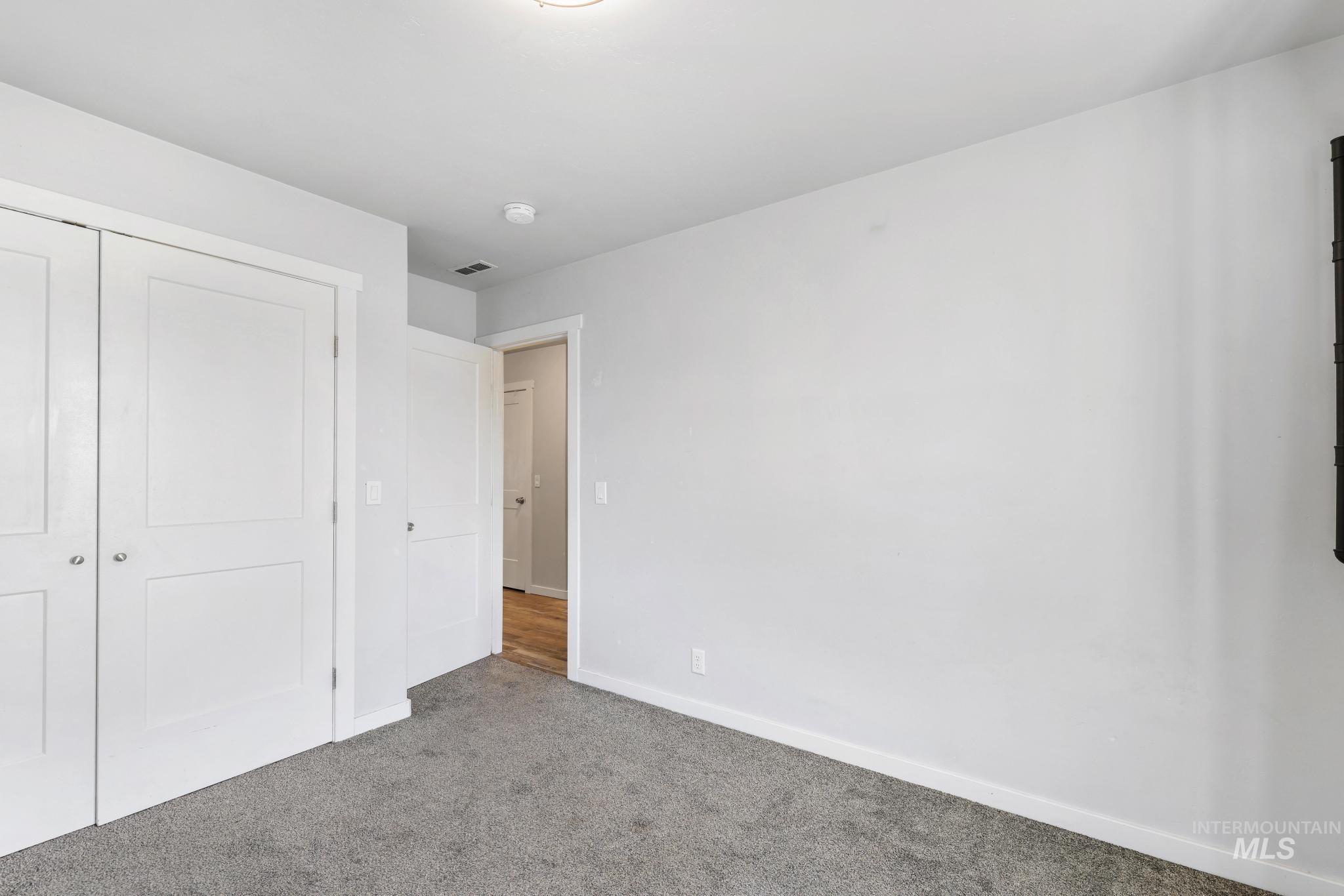 826 Normal Burley, ID 83318 - Photo 15 of 21 Carpeted interior space featuring white walls and a white ceiling with a flush-mount light fixture