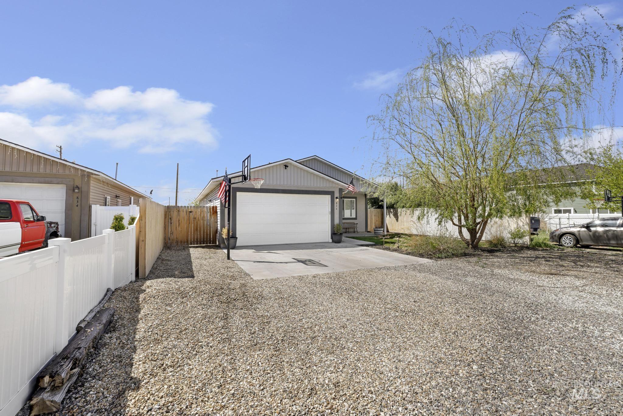 826 Normal Burley, ID 83318 - Photo 2 of 21 Contemporary exterior featuring gray siding, a white garage door, and a concrete driveway