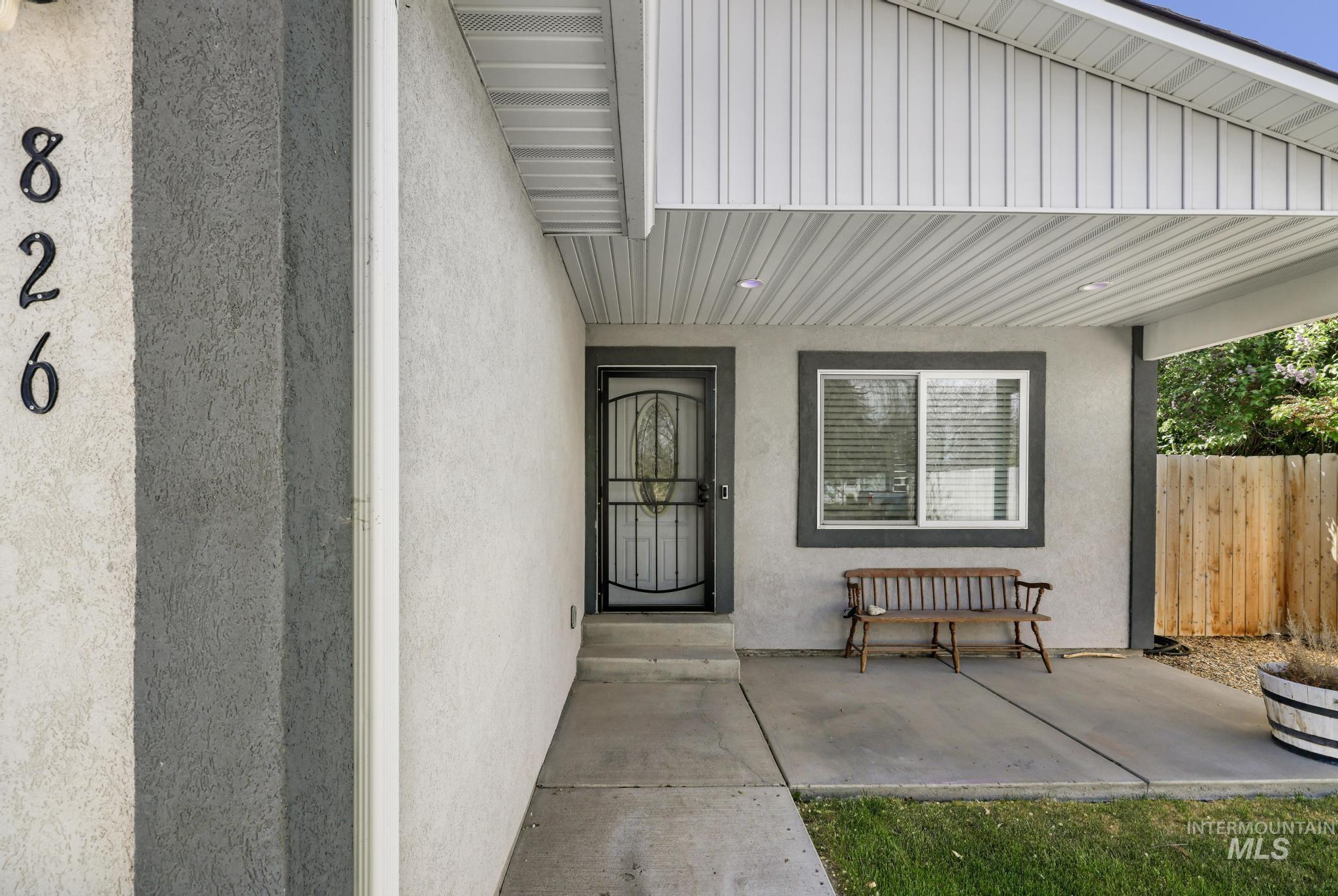 826 Normal Burley, ID 83318 - Photo 3 of 21 Covered front entry featuring a security door, adjacent window with blinds, and concrete patio