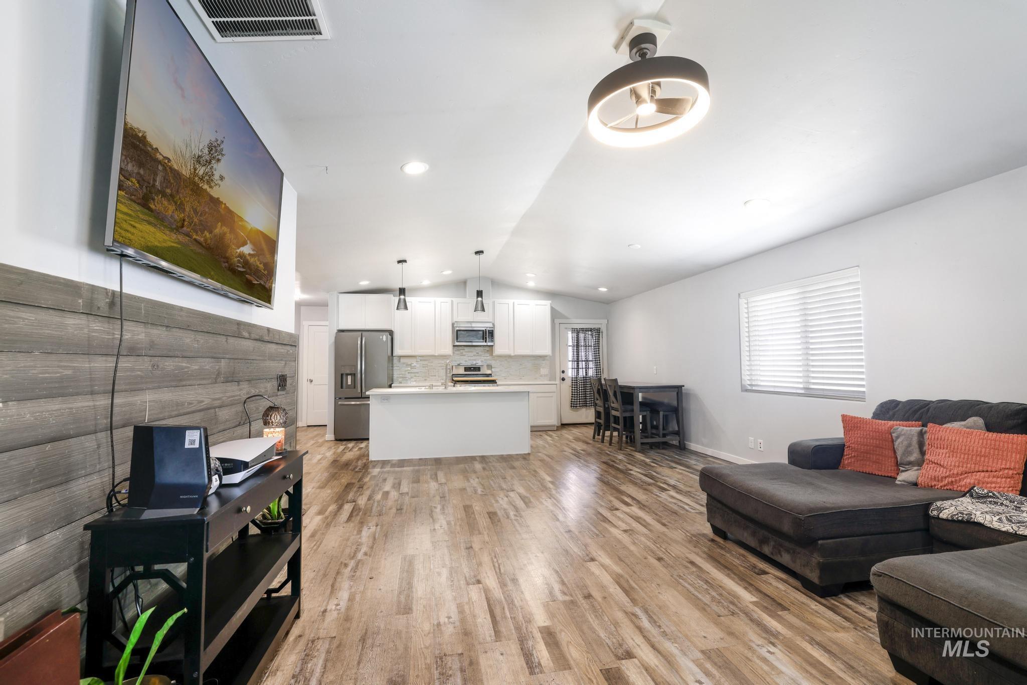 826 Normal Burley, ID 83318 - Photo 4 of 21 Open-concept living space featuring wood-finish flooring, recessed lighting, and a modern ceiling fan