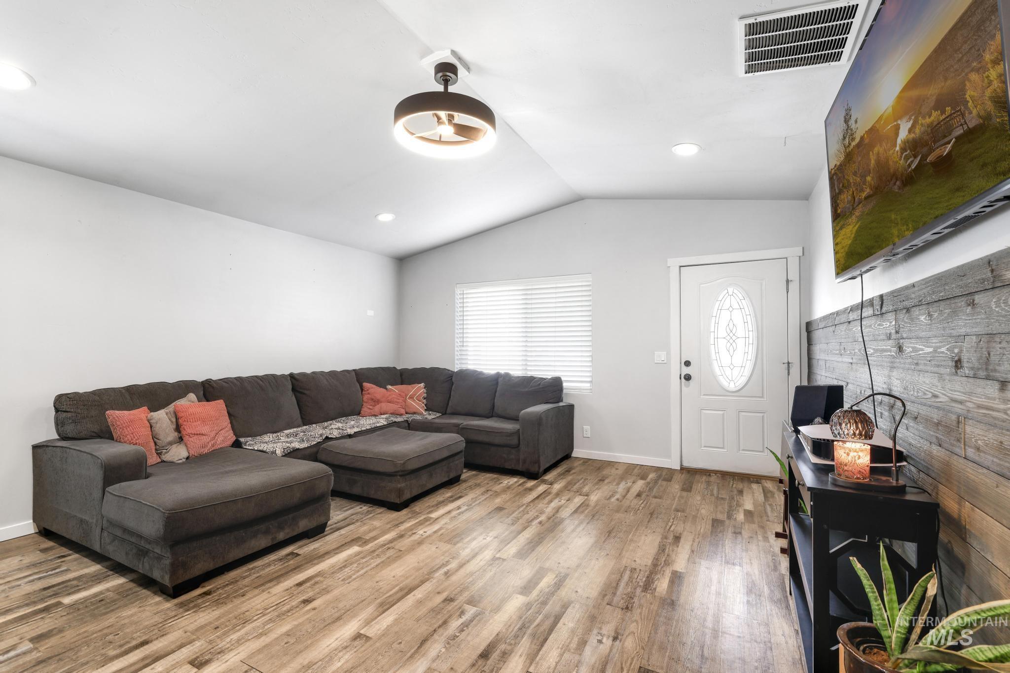 826 Normal Burley, ID 83318 - Photo 5 of 21 Spacious living area featuring wood-finish flooring, vaulted ceilings, and recessed lighting