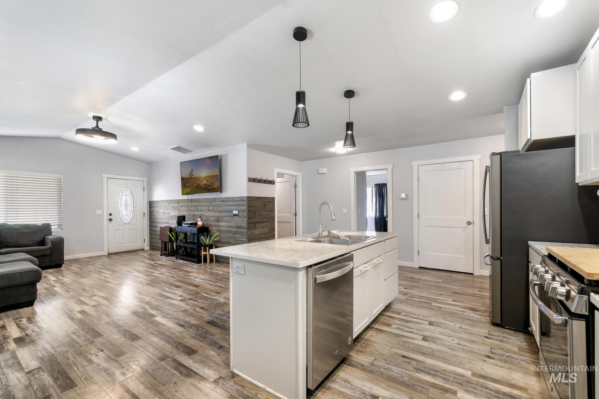 826 Normal Burley, ID 83318 - Photo 10 of 21 Kitchen island with a light-toned countertop, stainless steel sink, and integrated dishwasher