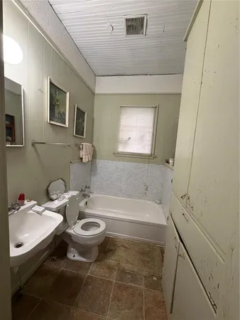 a bedroom with bed and window