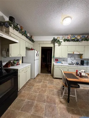 a kitchen with a sink cabinets and appliances