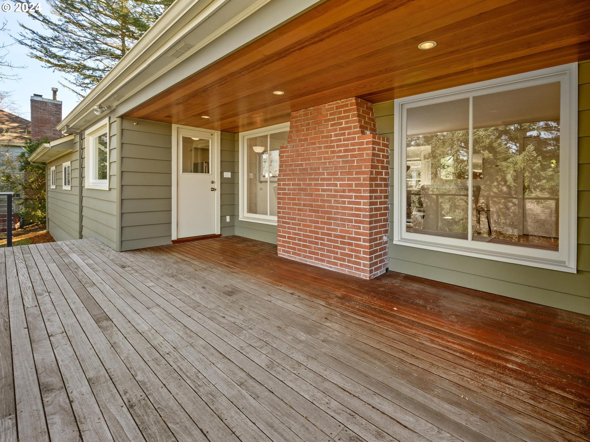 6435 Southwest Brugger Street Portland, OR 97219 - Photo 14 of 43 a view of an empty room with wooden floor and a window