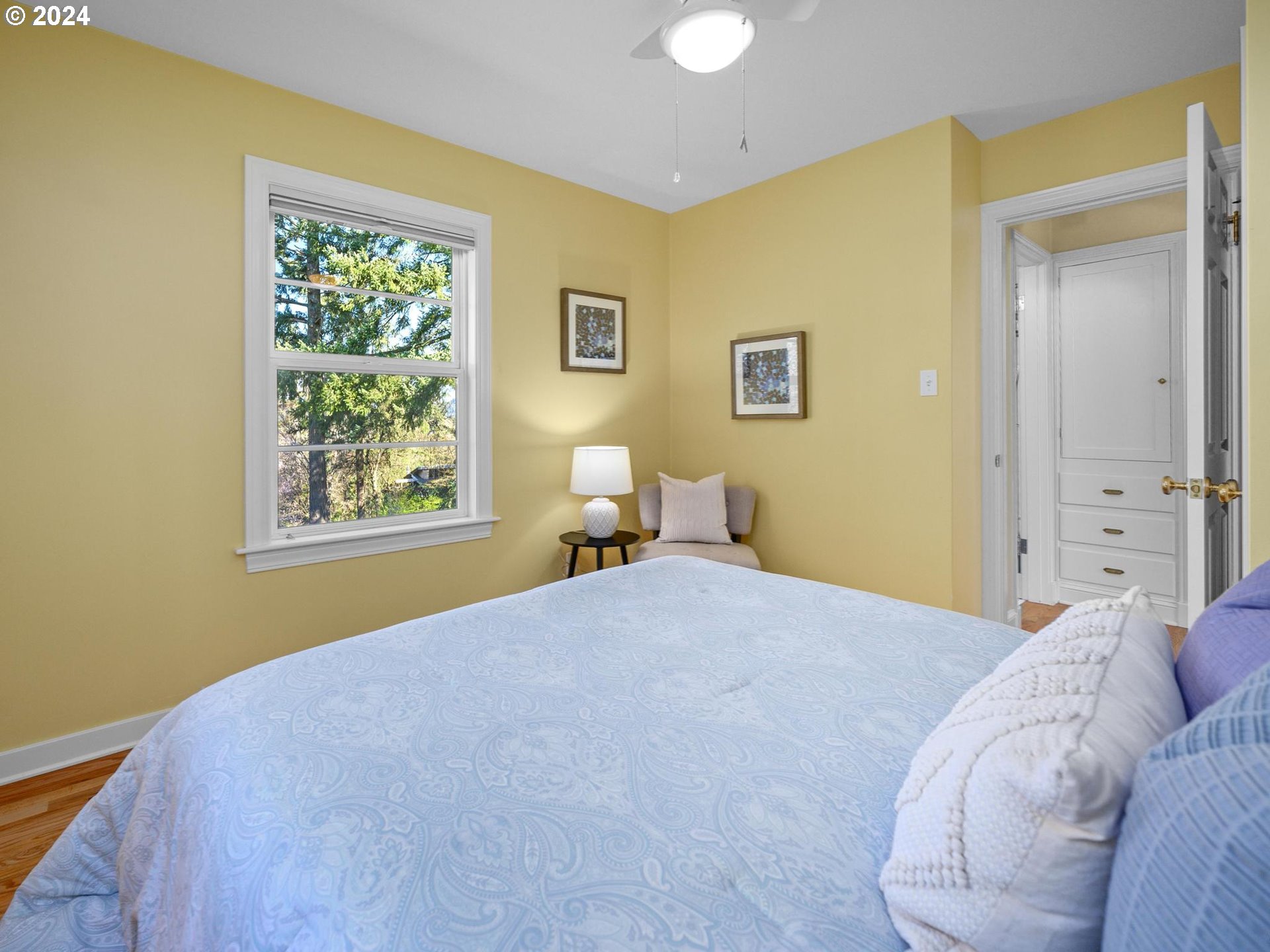 6435 Southwest Brugger Street Portland, OR 97219 - Photo 20 of 43 a bedroom with a bed and a window